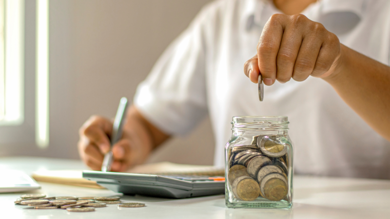 placing coins in jar